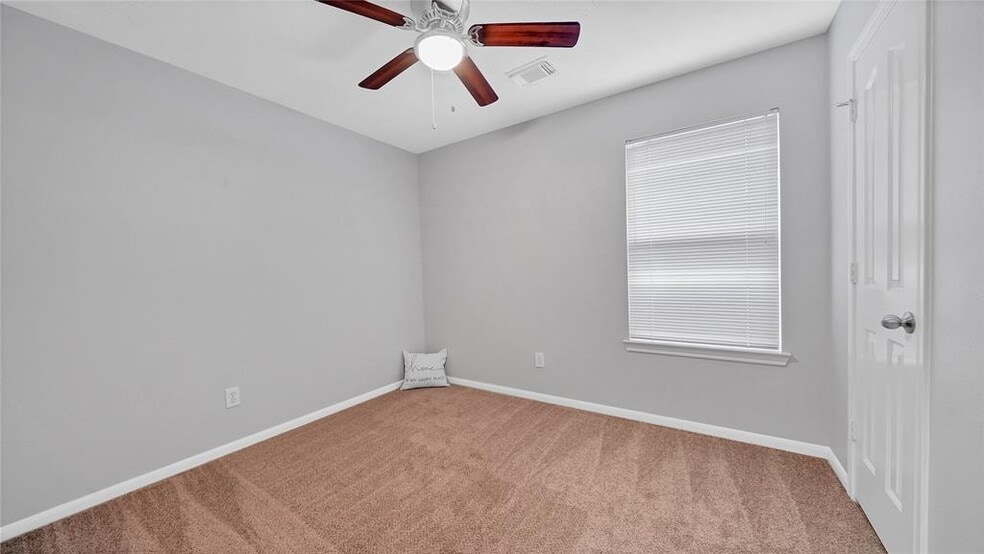Bedroom 2 with new ceiling fan - 5023 Deer Point Dr
