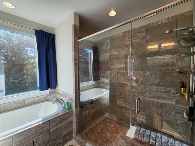Designer tiles provide tasteful elegant for the spacious shower room - 2039 Cartier Way