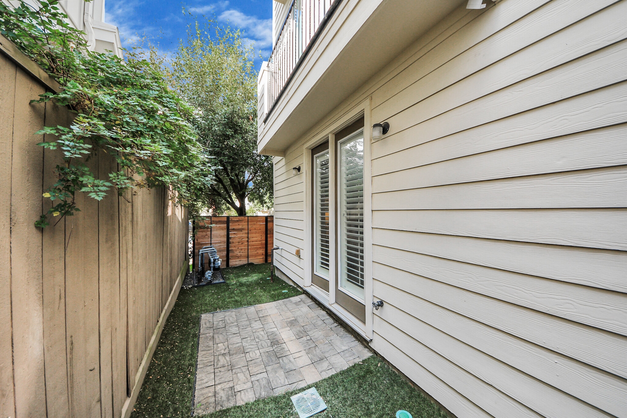 A charming gated patio ideal for morning coffee or evening breeze. - 620 Rutland St