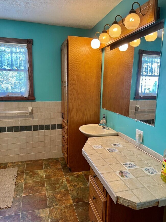 Building Photo - Country living! 1st floor laundry 3+ car garage with work shop