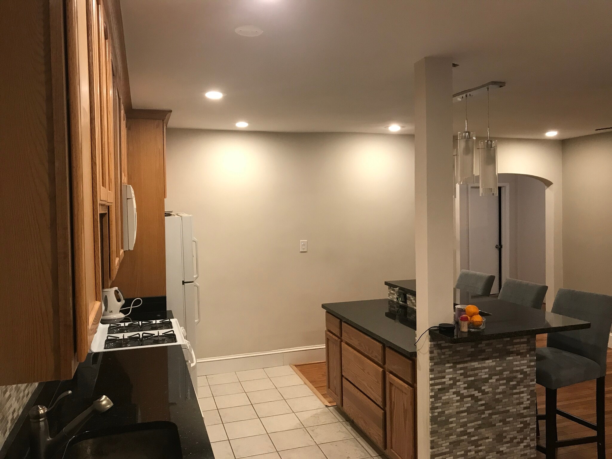 Open floor plan- furnished kitchen with cookware and silverware, furnished island with bar stools - 3719 12th St NE