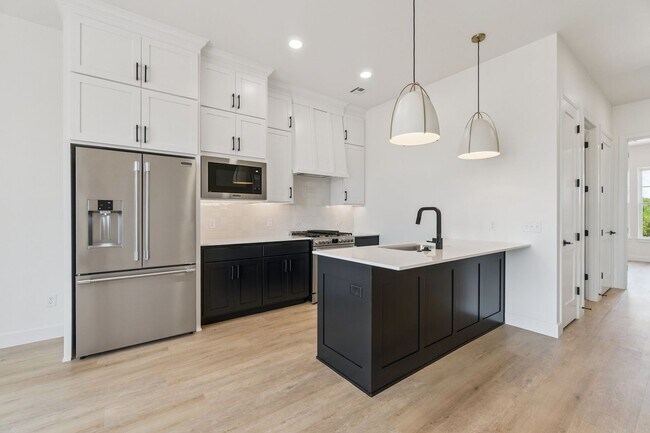 Building Photo - Bright. Clean. Calm. Your Elevated One-Bed...
