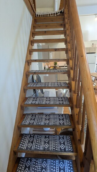 Natural wood stairs up to the loft - 156 Henry St