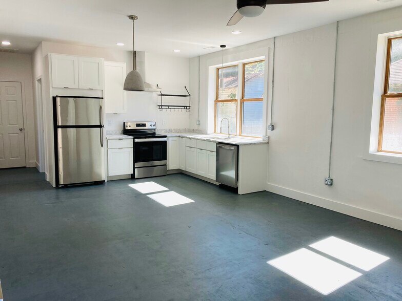 Open Concept Eat-in Kitchen with Designer Modern Concrete Dining pendants - 1311 Blair St
