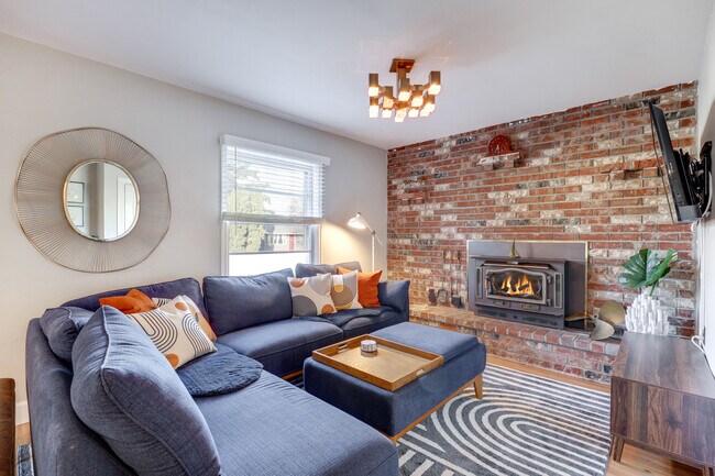 Living room with wood burning fireplace - 6620 SE Reedway St