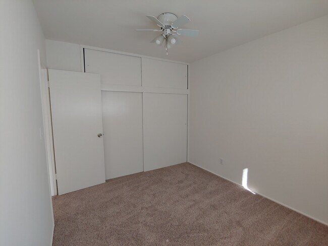 Back Bedroom with closets and upper cupboard storage (door to hallway) - 147 S Myrtle Ave