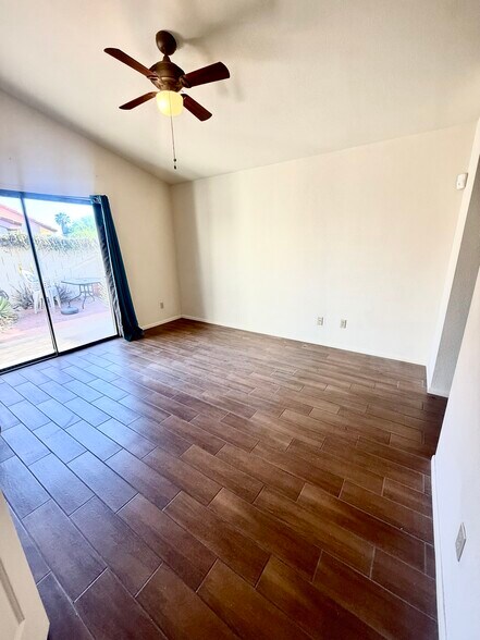 Primary bedroom with sliding door to back yard and ceiling fan - 200 E Belcourte Pl