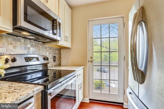 Kitchen with entrance to private balcony. - 1415 E Abingdon Dr