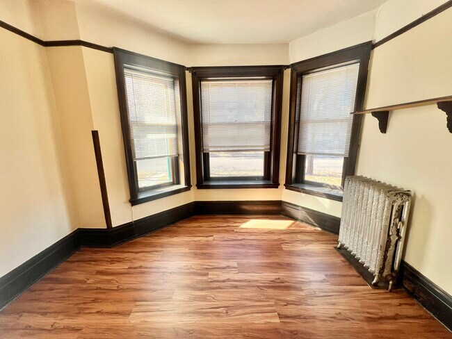 Bask in natural light in this inviting space, perfect for cozy living. - Cross Apartments