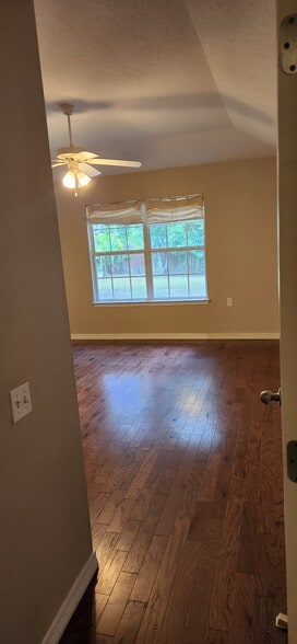 Master bedroom with double window view of fenced back yard - 2318 Tall Oak Dr