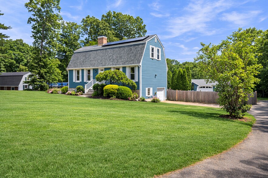 Side view of home showing driveway and fenced in backyard - 16 Miller Rd