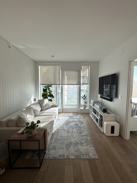 Living room with partial shades down - 188 W Saint James St