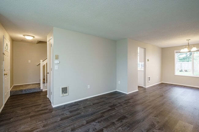 Building Photo - Recently Updated with Wood Laminate Flooring and Fresh Paint