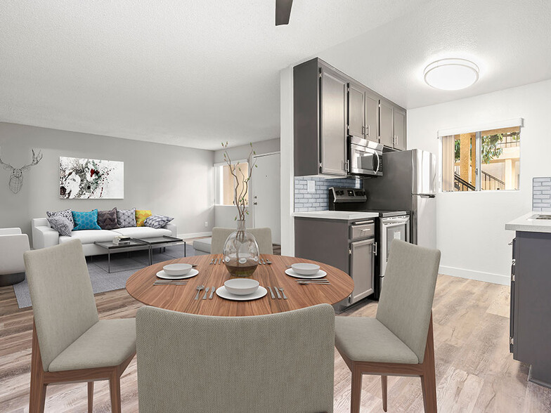 Dining room with hardwood floor and view of living room and tiled and stainless steel kitchen. - Riverbridge Apartments