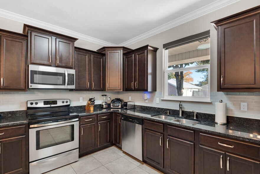 Kitchen has cooking appliances, cookware, utensils, and dishware - 28 Snook Rd