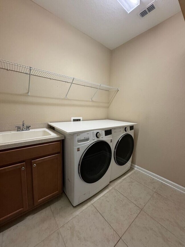 Building Photo - COMING SOON! Beautiful 4BR 3BA Home w/ Screened Lanai & Pond View • Garage Parking • Fenced Yard ...