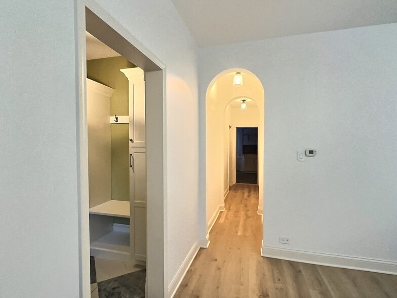 hallway with arched doorways and new flooring - 712 45th St
