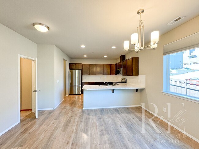 Building Photo - Modern End-Unit Townhome with Private Fenced Yard, Gourmet Kitchen & Spacious Layout