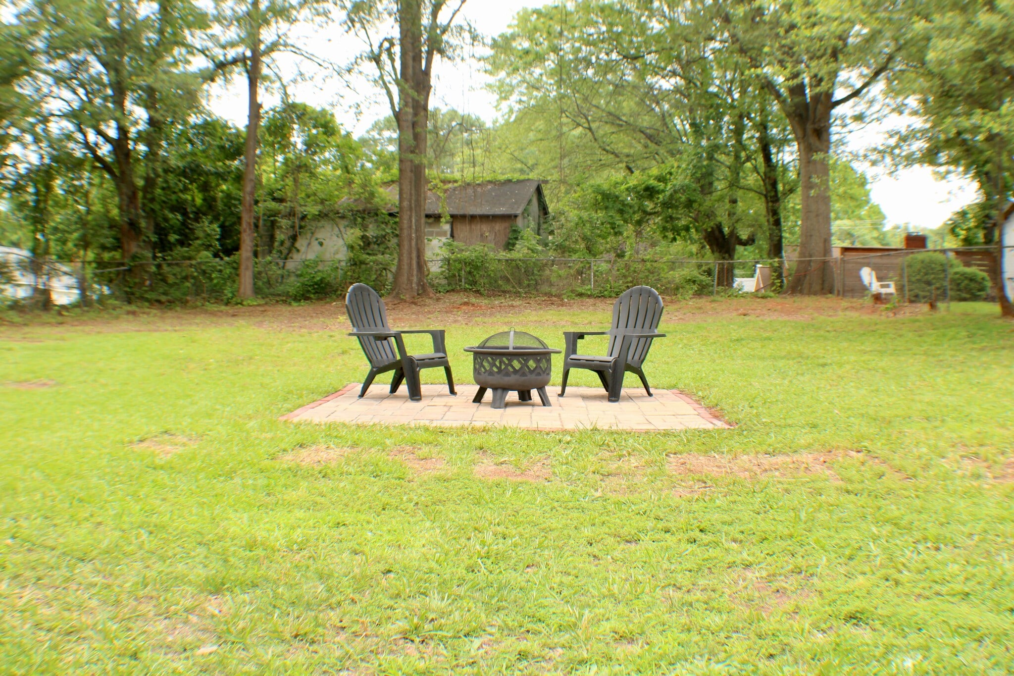 Patio with firepit in spacious, fenced-in backyard (firepit and chairs not included) - 311 Paris Mountain Ave
