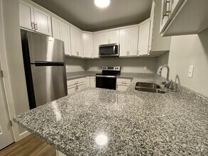 Building Photo - Modern Comfort Meets Urban Convenience in ...