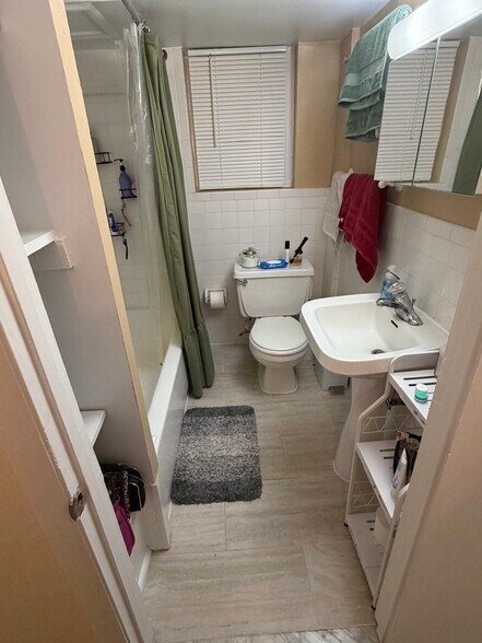 Tub shower from doorway. New tile floor. - 1336 Kenyon St NW