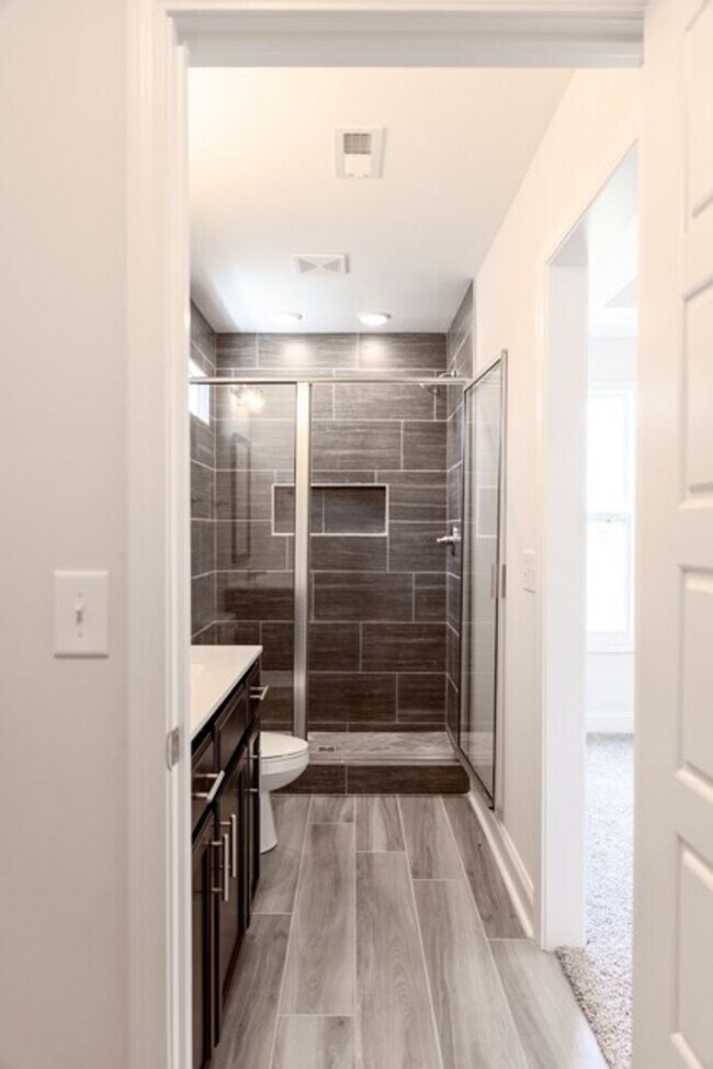 Building Photo - Modern Living Redefined with Stone Fireplace, Gray Cabinetry, Spa Inspired Primary Suite and Cove...