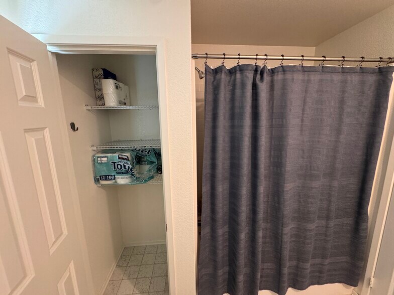 Hall bathroom storage closet and tub enclosure - 15659 Whispering Creek Way