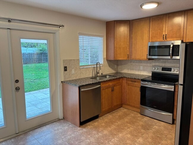 Building Photo - 2/2/1 home with a spacious fenced backyard...