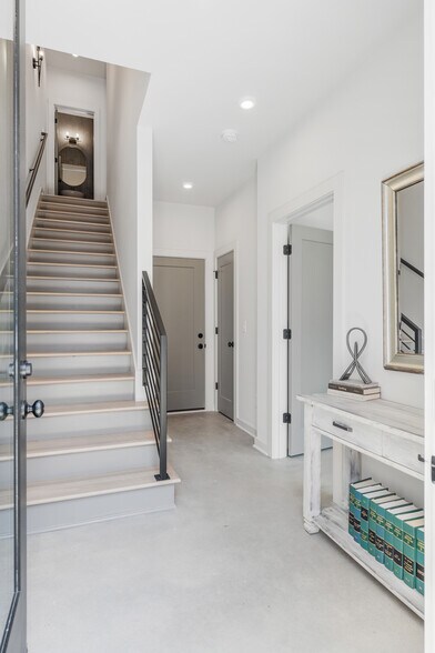 Entry that feels both open and elevated, with access to a private suite and bathroom on first floor - 358 E Village Ln