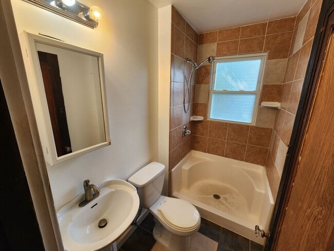 Building Photo - 4 BR home with first-floor living, new roof, and a private-feeling backyard in Lincoln Place