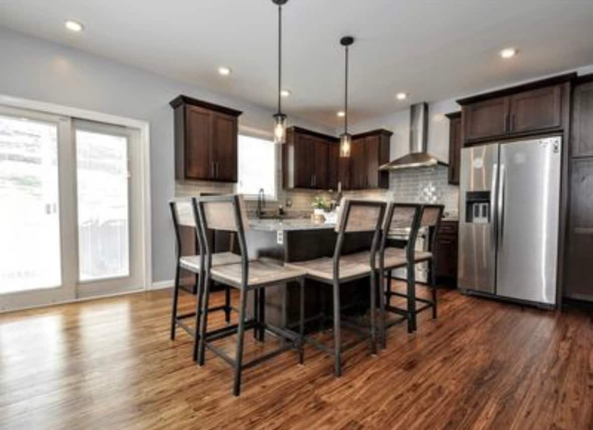 Open kitchen and dining area with hardwood floors - 2328 Primrose St