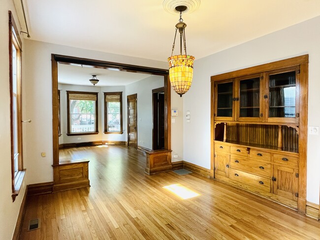 Dining Room with Tiffany chandelier & built in cabinet (living room in background) - 4259 N Lawndale Ave