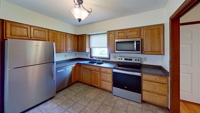 Building Photo - Updated two bedroom duplex, new stainless steel appliances, garage, and hardwood floors