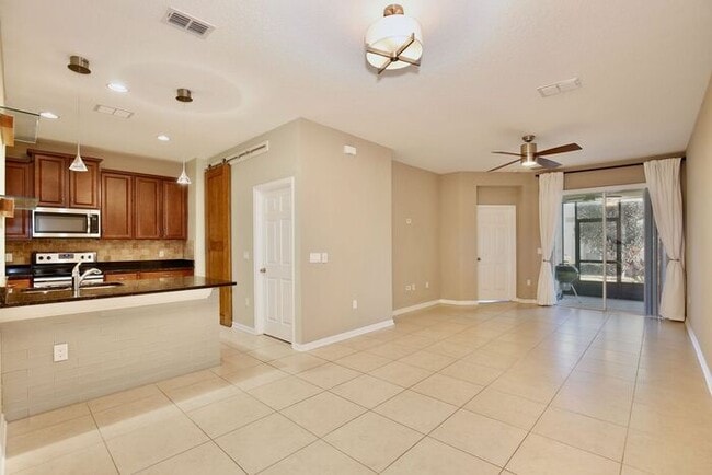 Building Photo - Gorgeous 4/2.5 Spacious Townhome with a Loft Area and a 2 Car Garage in the Desirable Gated Commu...