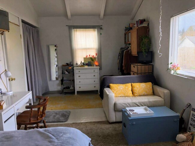 Same bedroom with built-ins on the right and closet, entry door on the left. The room has a vaulted ceiling - 804 NW 29th St