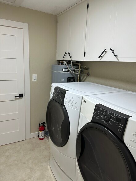 The laundry room has plenty of storage and a washer and dryer. - 1879 N Jantzen Ave