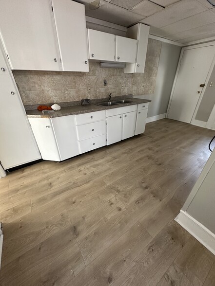 Kitchen with all new flooring. - 134 Pearl St