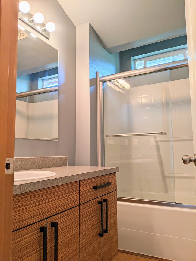 Full bath with modern style cabinets and lots of storage - 4810 S Holly St