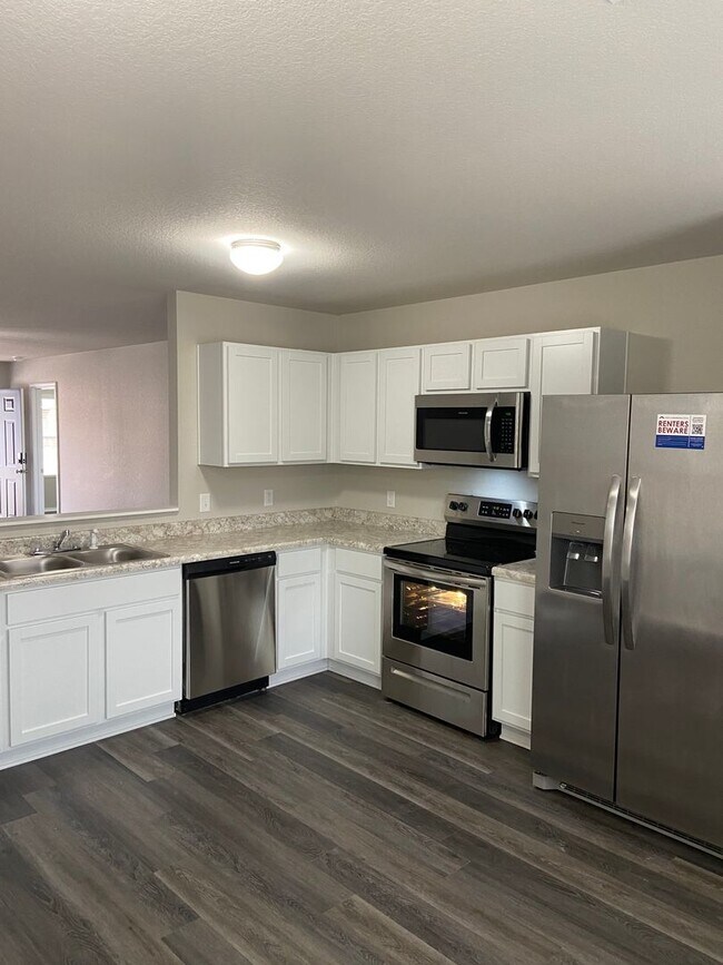 Building Photo - NOW AVAILABLE — Spacious Living in This 4-Bedroom | 2-Bath Conrad Court Home