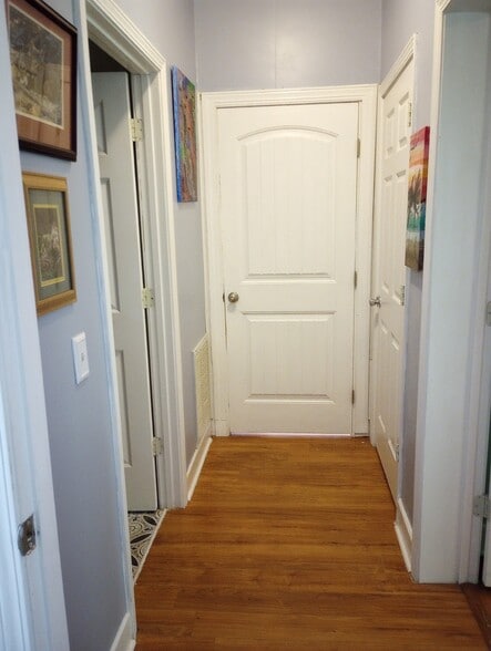Hallway with bedroom (behind door), kitchenette, and bathroom - 5718 Wildlife Rd
