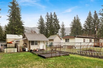 View from back of lot looking at raspberry bushes, raised beds, shed and home - 8491 Cimarron Way