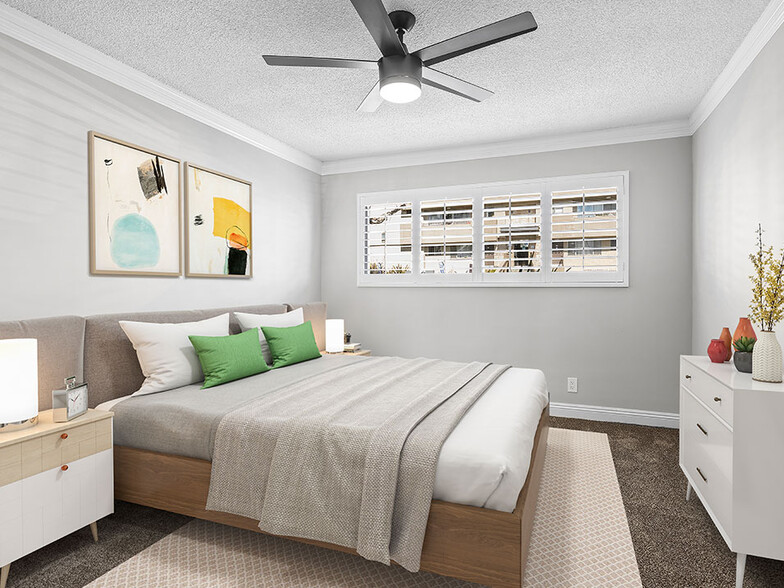 Carpeted bedroom with ceiling fan. - Rose Avenue