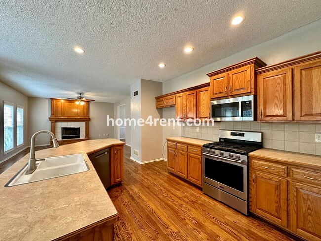 Building Photo - Beautiful Four-Bedroom Home with Three Car Garage, Wood Floors, Finished Basement and a Fenced Ya...