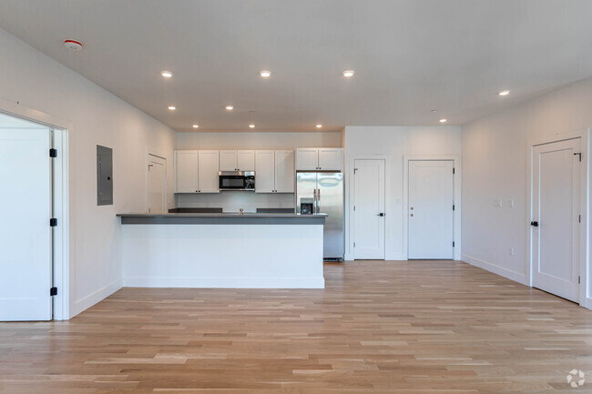 Unit 401 kitchen and living area. - The Residence at 581 Salem St