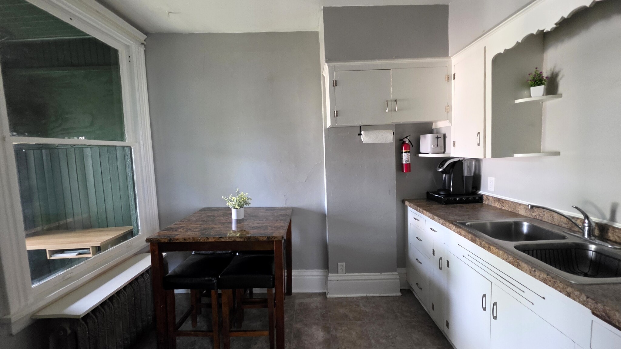 Bright eat-in kitchen with coffee maker, microwave, and everything needed for extended stays. - 822 E 4th St