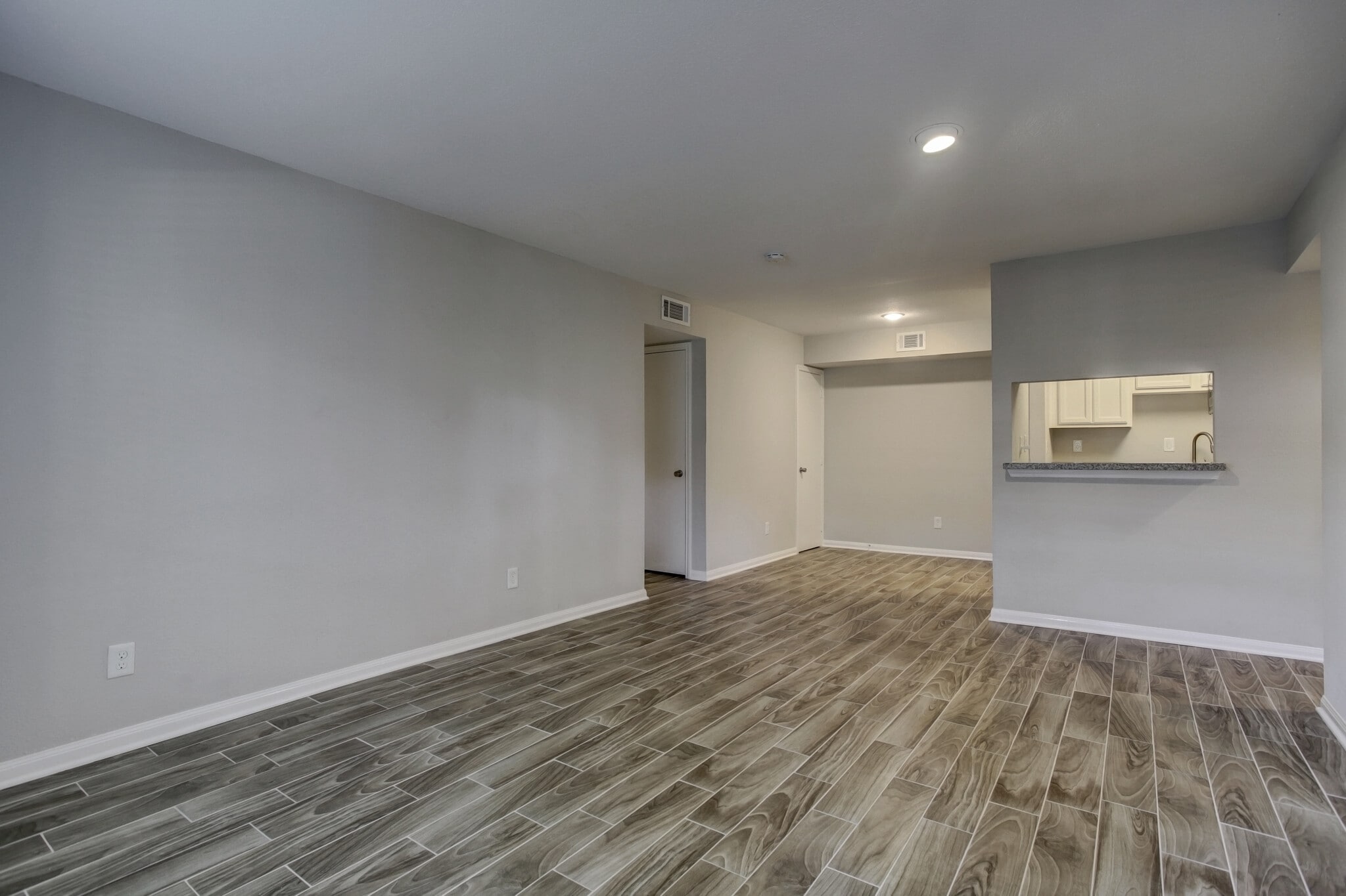 View of the living and dining rooms - view without furniture. - 1880 White Oak Dr. Apt 119