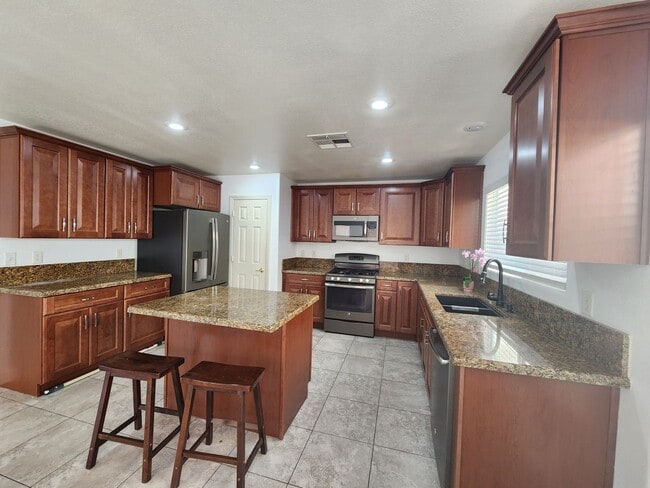 Building Photo - Sleek 2 story home with tile in most living areas and upgraded kitchen.