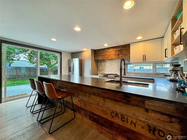 Building Photo - Remodeled 3 bdrm home on a large lot with 500 sq ft wrap around deck!