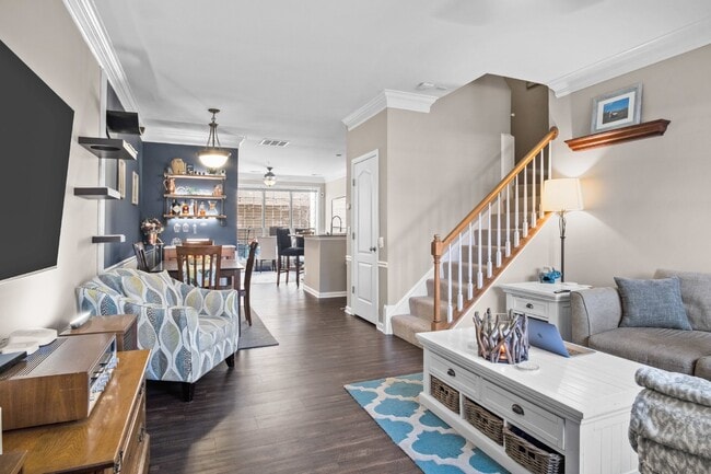 Building Photo - This inviting two-level townhome offers comfort and style, featuring gleaming hardwood floors on ...
