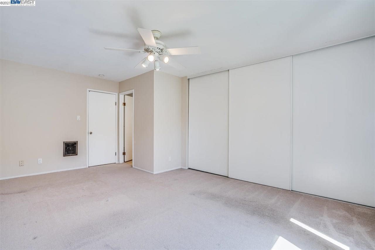 Primary bedroom with full closet - now has wooden flooring - 9005 Alcosta Blvd